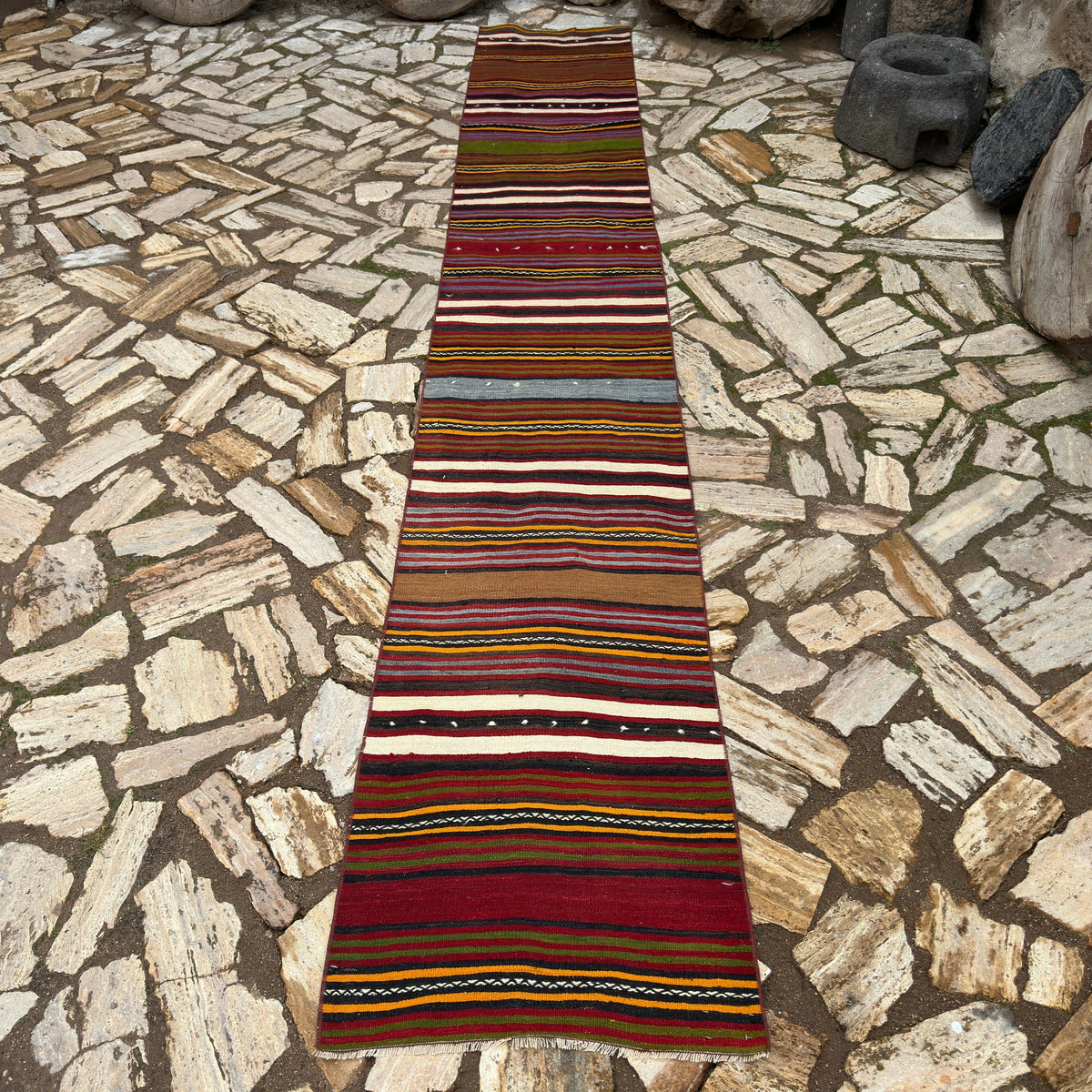Red 2' x 13' vintage Turkish striped runner rug in wool and cotton, shown on the floor.