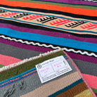 Close-up of the pink vintage Turkish striped runner rug showing striped details, flatweave construction, wool and cotton and low pile.