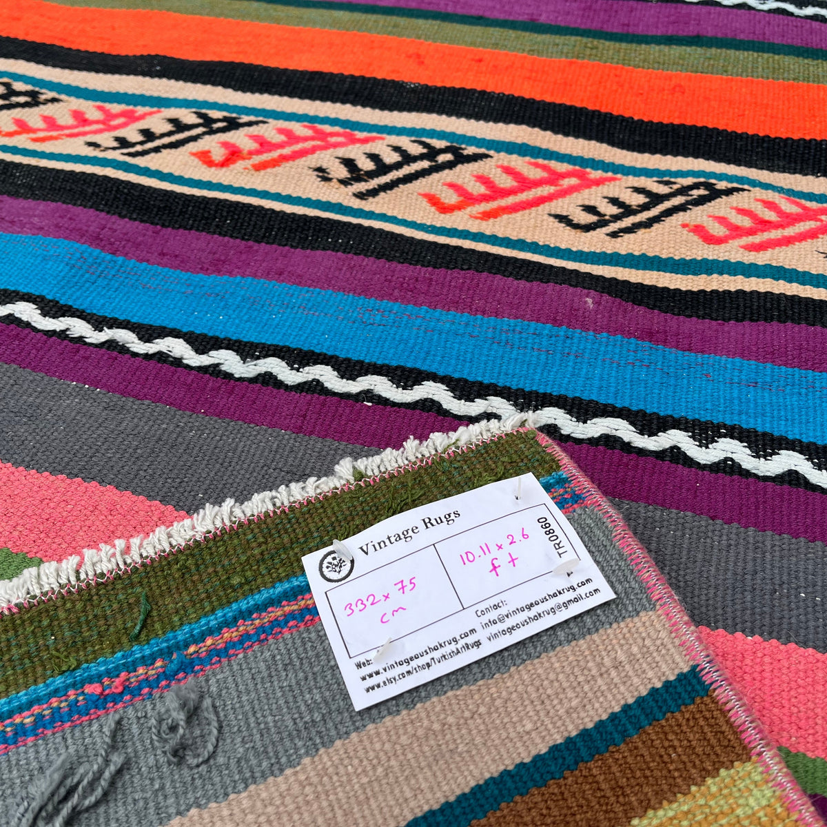 Close-up of the pink vintage Turkish striped runner rug showing striped details, flatweave construction, wool and cotton and low pile.