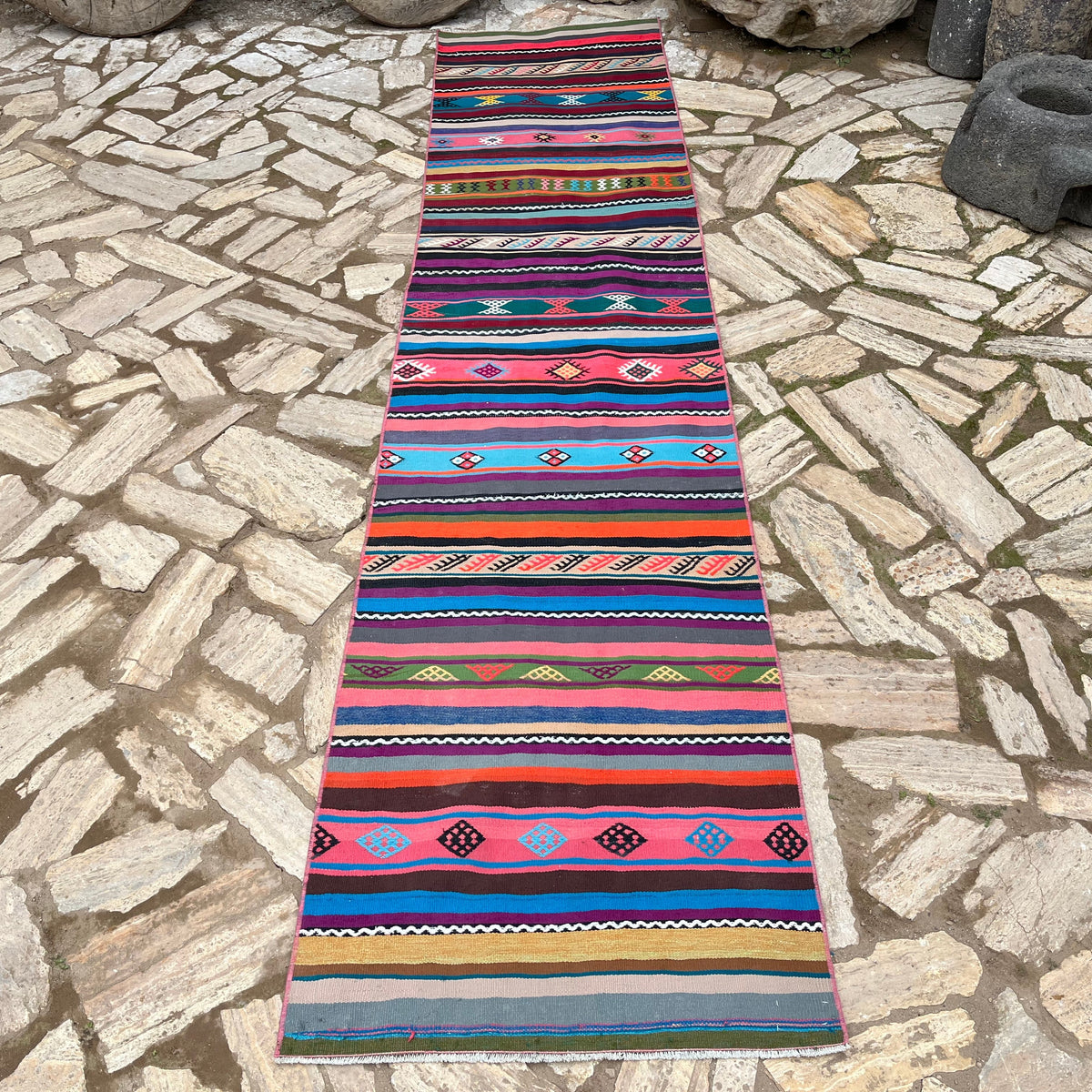 Pink 3' x 11' vintage Turkish striped runner rug in wool and cotton, shown on the floor.