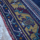 Blue 5' x 9' vintage Turkish tradiitonal rug in wool and cotton, shown on the floor.