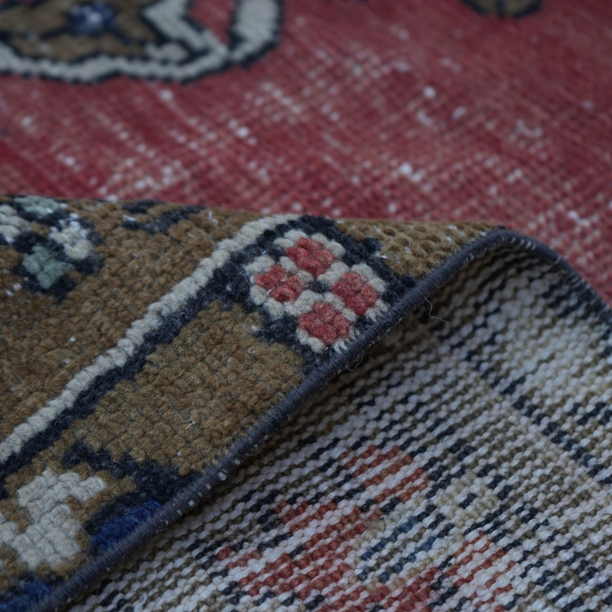 Additional view of the red vintage Turkish tradiitonal rug, hand-knotted in wool and cotton.
