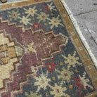 Close-up of the gray vintage Turkish traditional rug showing traditional details, hand-knotted weave, wool and cotton and low pile.
