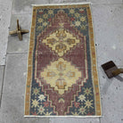 Gray 2' x 3' vintage Turkish traditional rug in wool and cotton, shown on the floor.