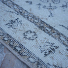 Beige 4' x 6' vintage Turkish traditional rug in wool and cotton, shown on the floor.
