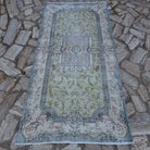 Pale Green 4' x 7' vintage Turkish traditional rug in wool and cotton, shown on the floor.