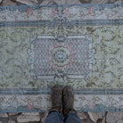 1970s pale green vintage Turkish traditional rug with traditional design, hand-knotted weave and low pile.