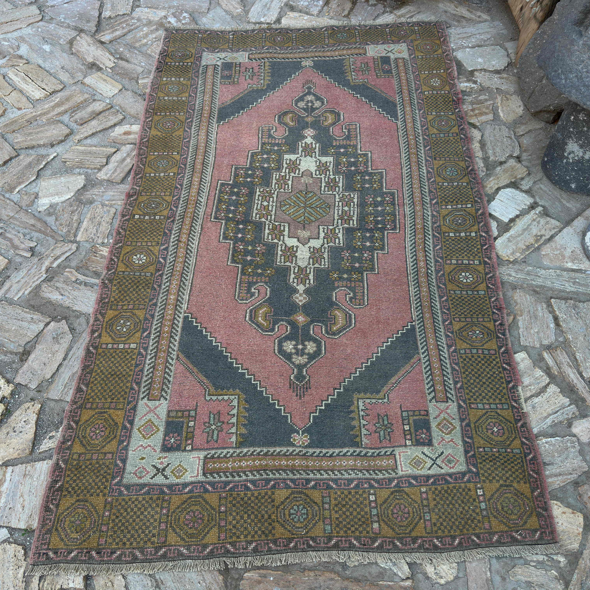 Pale Red 4' x 7' vintage Turkish traditional rug in wool and cotton, shown on the floor.