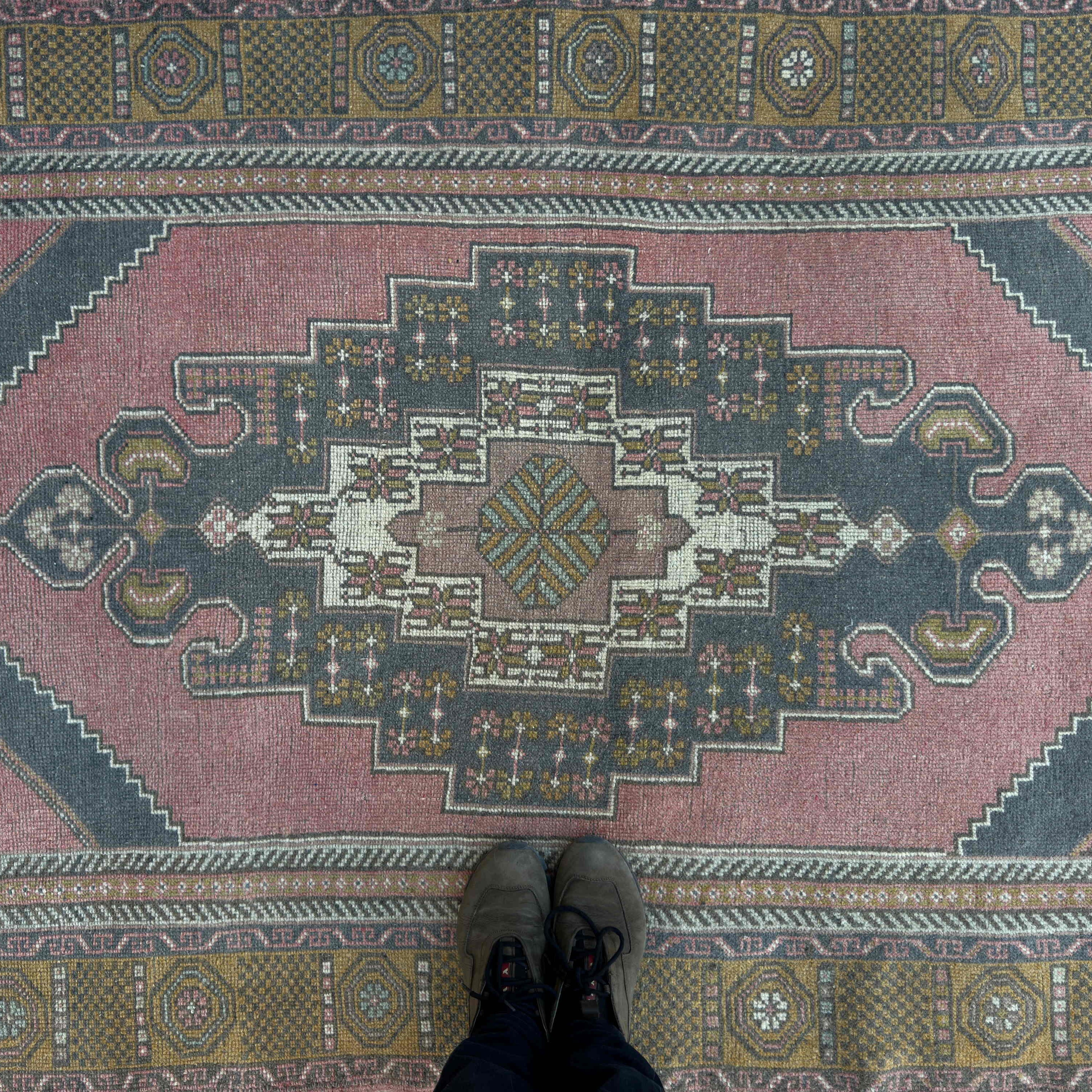 1970s pale red vintage Turkish traditional rug with traditional design, hand-knotted weave and low pile.