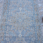 Close-up of the purple vintage Turkish traditional rug showing traditional details, hand-knotted weave, wool and cotton and low pile.