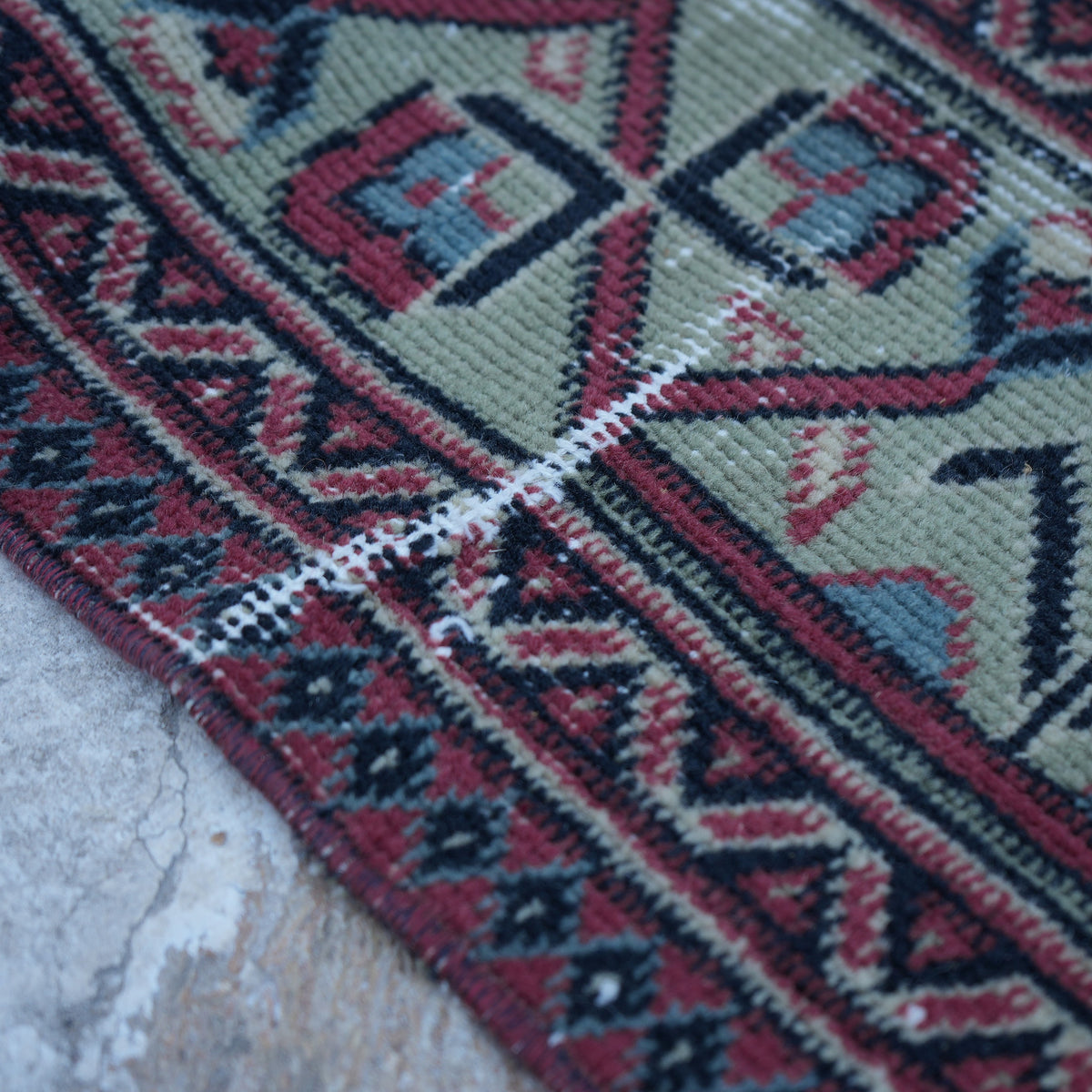 Red 5' x 7' vintage Turkish traditional rug in wool and cotton, shown on the floor.