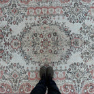1970s pale red vintage Turkish traditional rug with medallion design, hand-knotted weave and low pile.