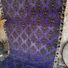Purple 5' x 9' vintage Turkish traditional rug in wool and cotton, shown on the floor.