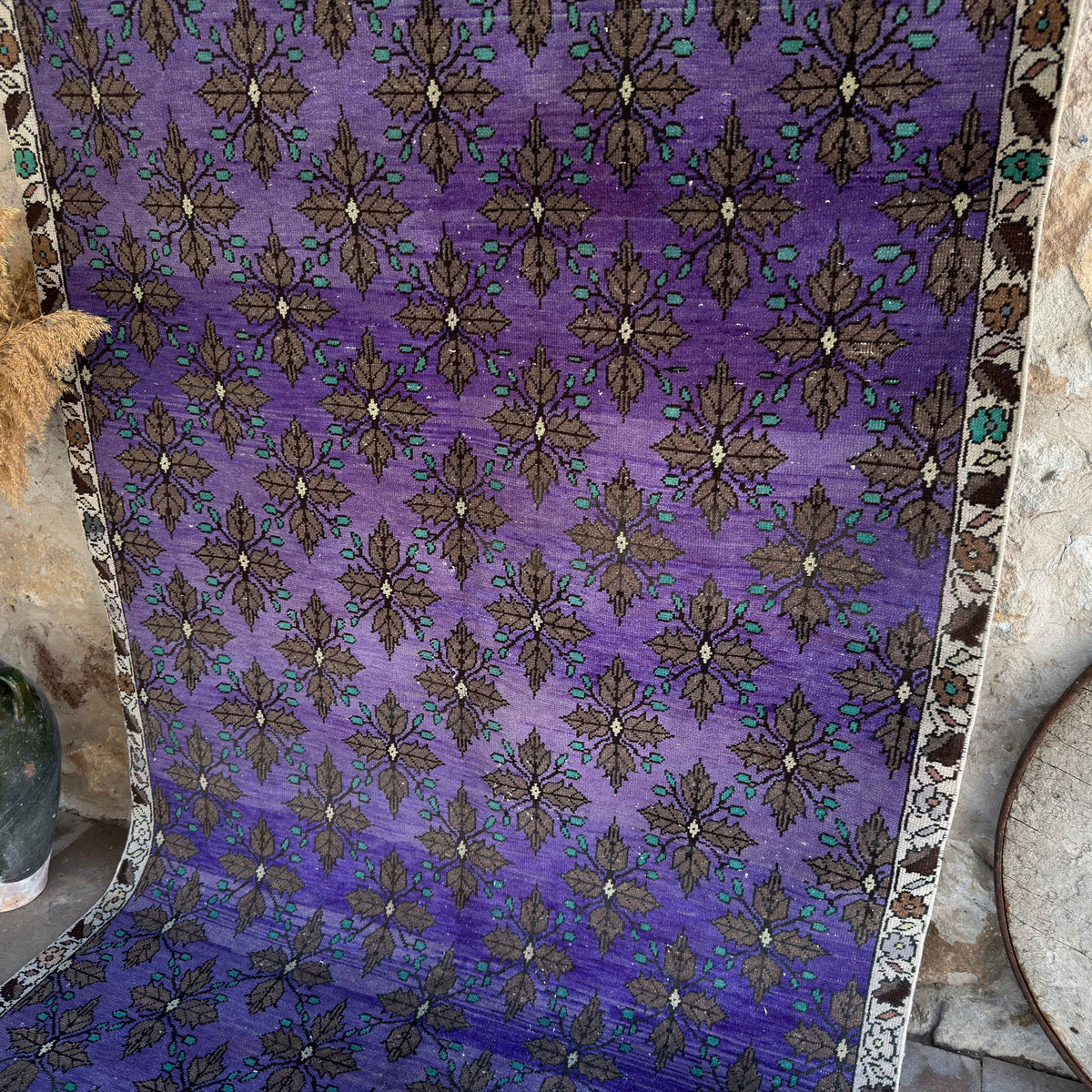Purple 5' x 9' vintage Turkish traditional rug in wool and cotton, shown on the floor.