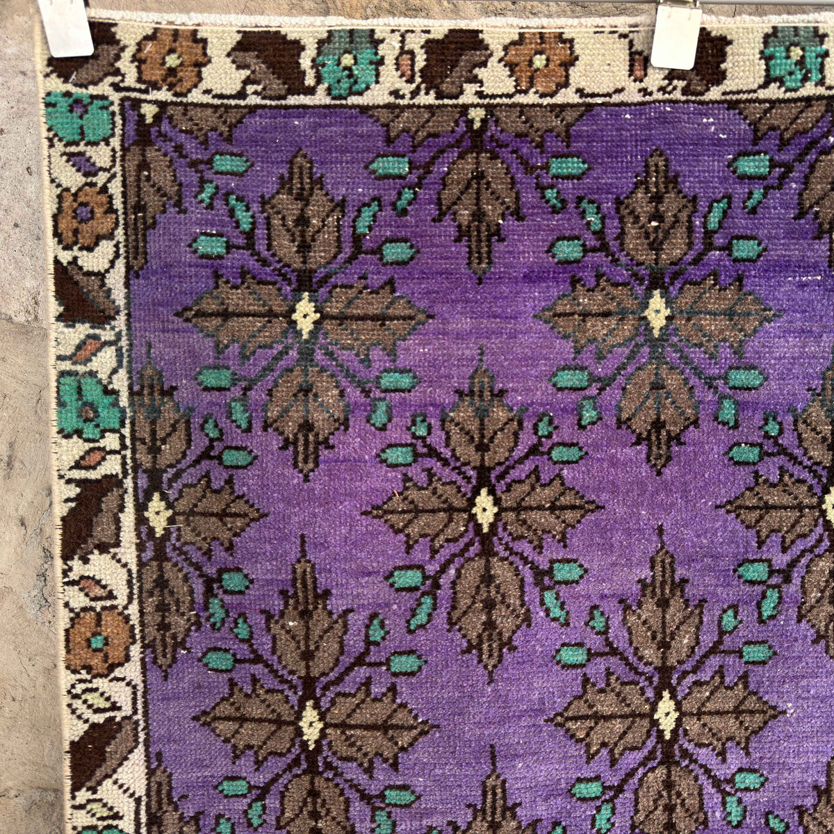 1970s purple vintage Turkish traditional rug with floral design, hand-knotted weave and low pile.