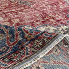 Close-up of the red vintage Turkish traditional rug showing medallion details, hand-knotted weave, wool and cotton and low pile.