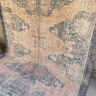 Pink 7' x 9' vintage Turkish traditional rug in wool and cotton, shown on the floor.