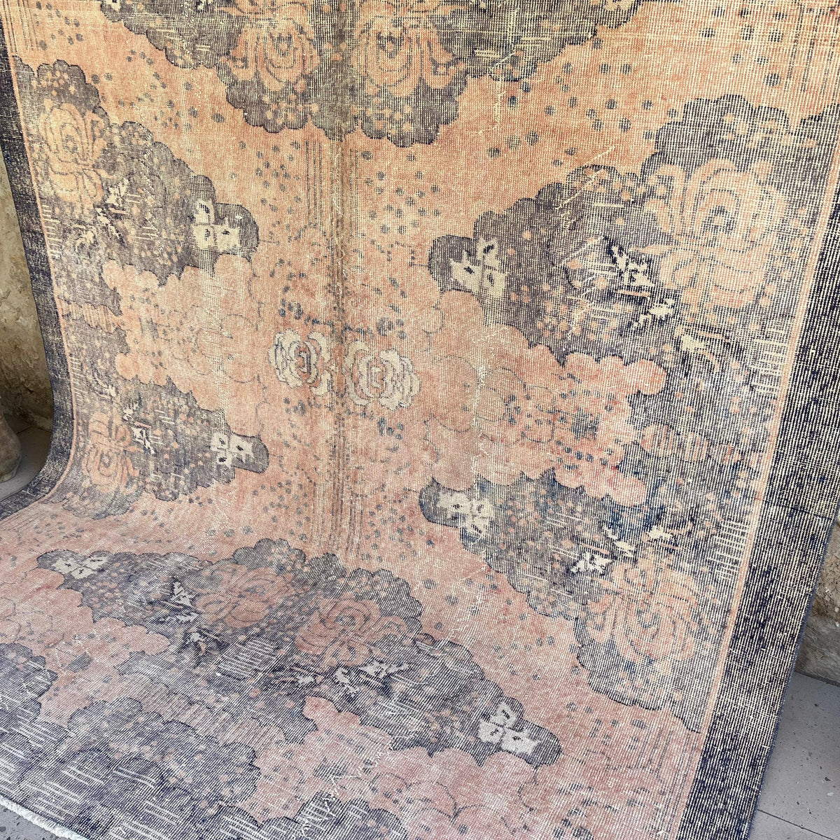 Pink 7' x 9' vintage Turkish traditional rug in wool and cotton, shown on the floor.