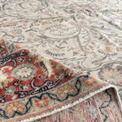 Close-up of the pale red vintage Turkish traditional rug showing medallion details, hand-knotted weave, wool and cotton and low pile.