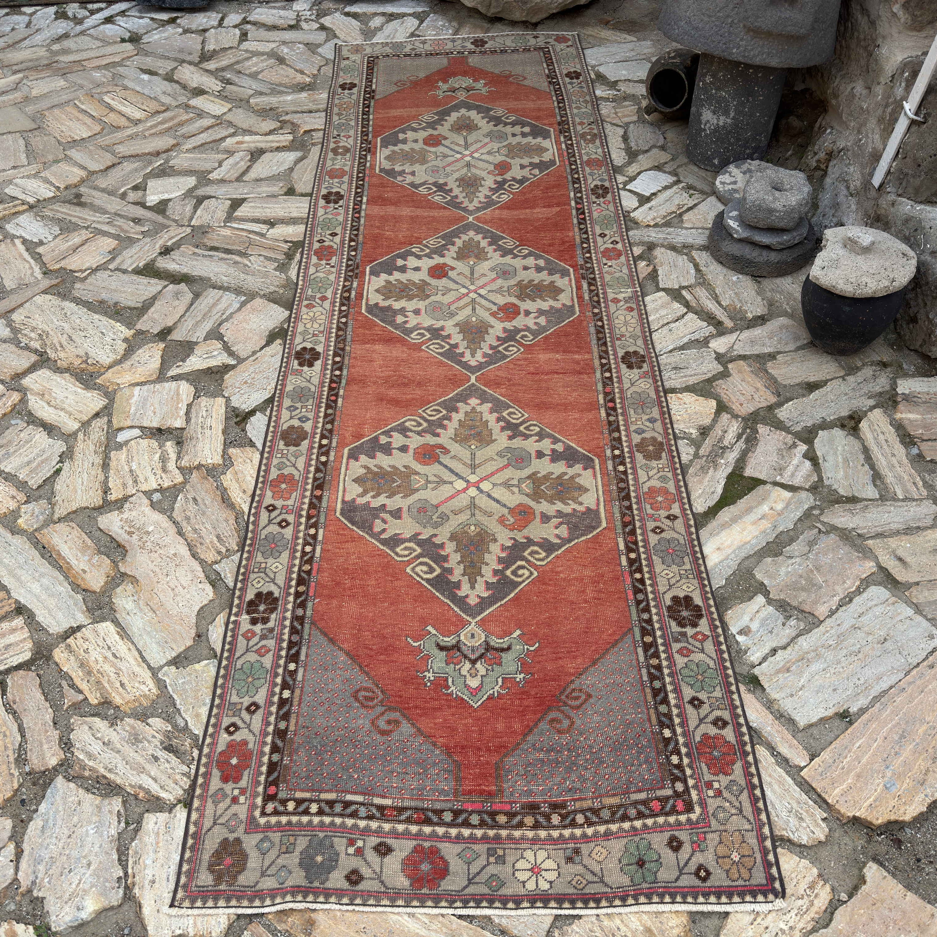 Red 3' x 11' vintage Turkish traditional runner rug in wool and cotton, shown on the floor.