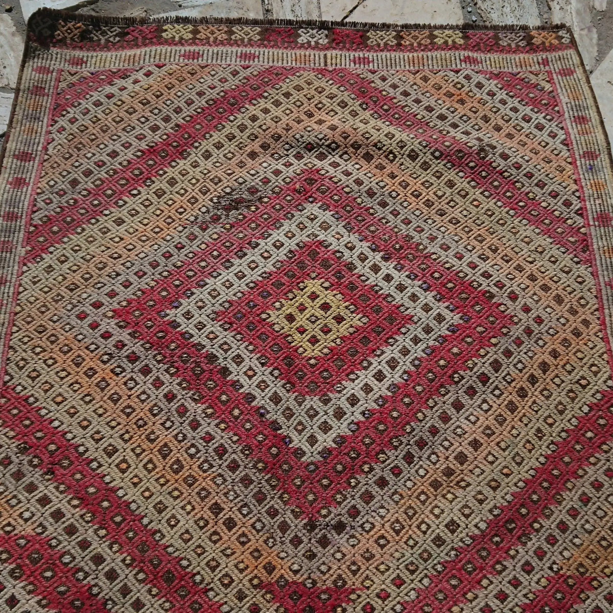 Brown 3' x 4' vintage Turkish tribal kilim rug in wool and cotton, shown on the floor.