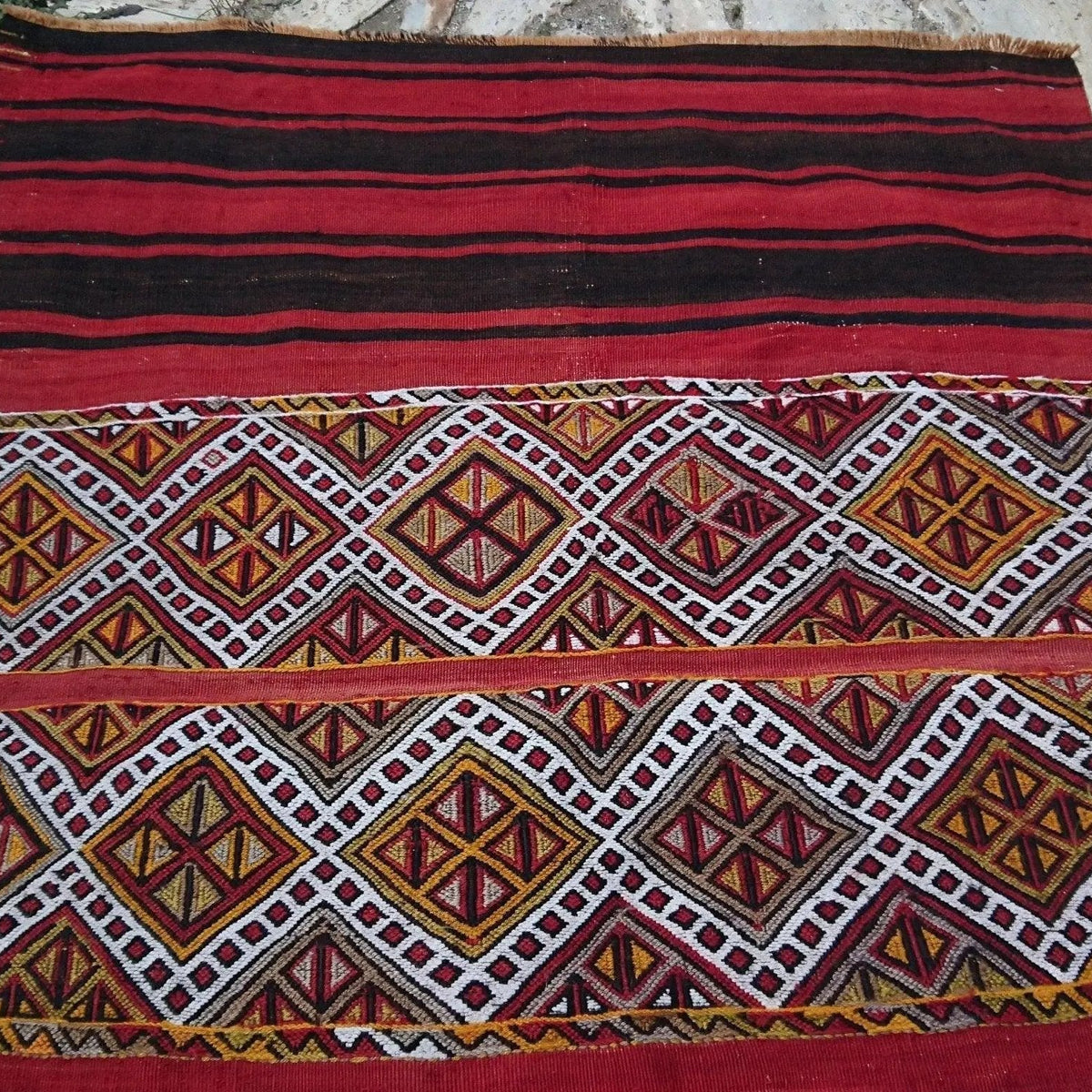 1970s red vintage Turkish tribal kilim rug with striped design, flatweave construction and low pile.