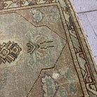 Close-up of the red vintage turkish carpet showing traditional and neutral details, hand-knotted weave, wool and cotton and low pile.
