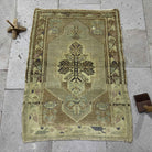 Red 2' x 3' vintage turkish carpet in wool and cotton, shown on the floor.