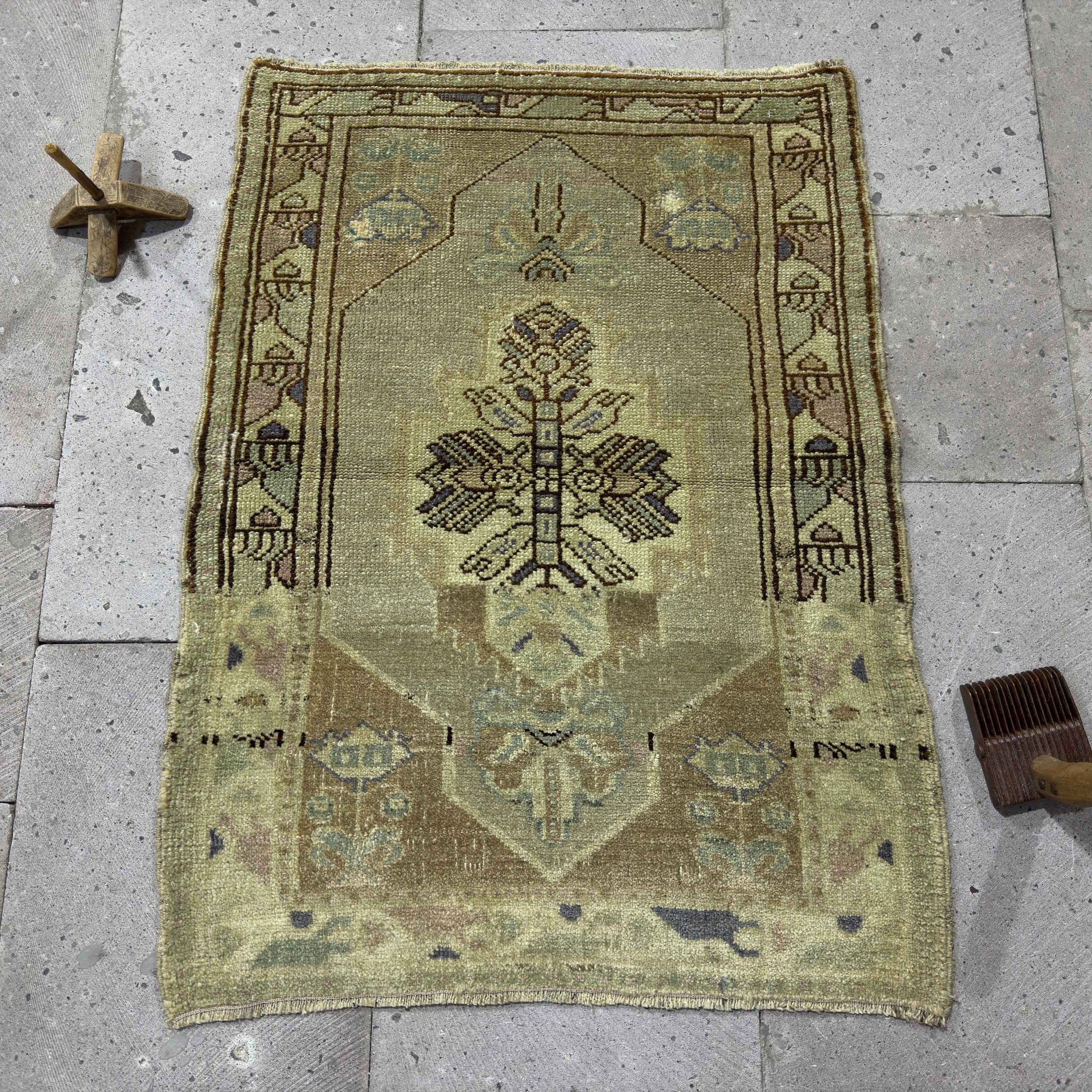 Red 2' x 3' vintage turkish carpet in wool and cotton, shown on the floor.