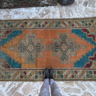1970s orange vintage turkish carpet with medallion design, hand-knotted weave and low pile.