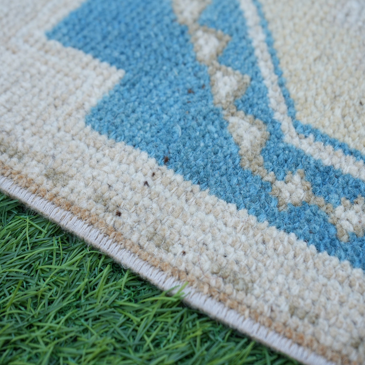 Blue 1' x 3' vintage turkish rug in wool and cotton, shown on the floor.