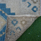 1970s blue vintage turkish rug with geometric design, hand-knotted weave and low pile.