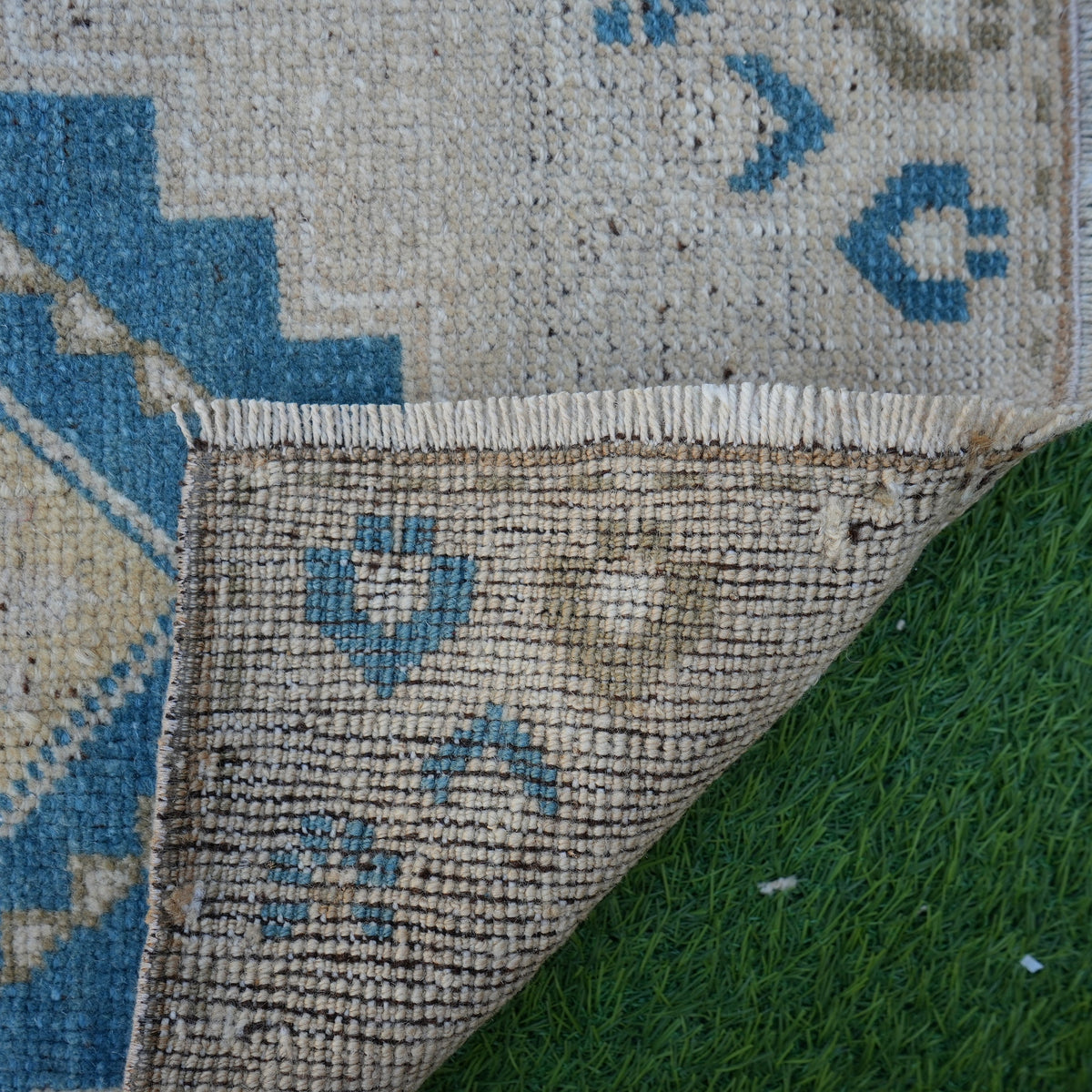 1970s blue vintage turkish rug with geometric design, hand-knotted weave and low pile.