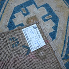 Blue 1' x 3' vintage turkish rug from the 1970s with geometric design.