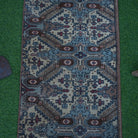 Close-up of the brown vintage turkish rug showing traditional details, hand-knotted weave, wool and cotton and low pile.