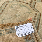 Close-up of the brown vintage turkish rug showing neutral details, hand-knotted weave, wool and cotton and low pile.