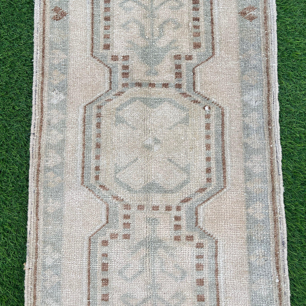 1970s brown vintage turkish rug with neutral design, hand-knotted weave and low pile.