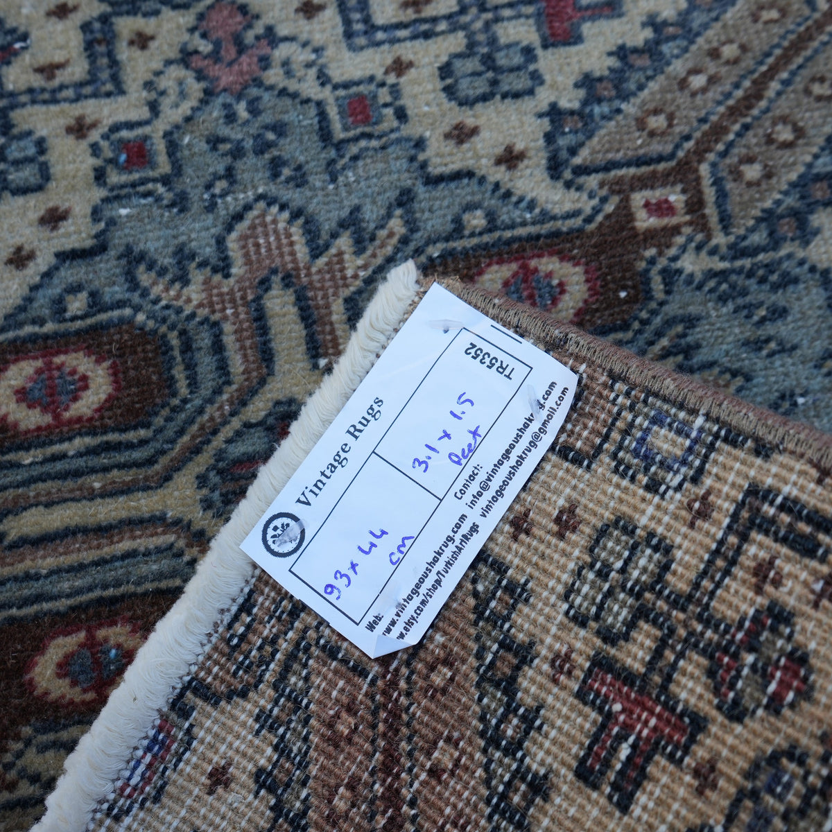 Brown 1' x 3' vintage turkish rug from the 1970s with traditional design.