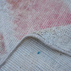 Additional view of the pale red vintage turkish rug, hand-knotted in wool and cotton.
