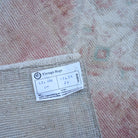 Pale Red 1' x 3' vintage turkish rug from the 1970s with neutral design.