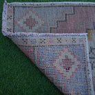 1970s pink vintage turkish rug with traditional design, hand-knotted weave and low pile.
