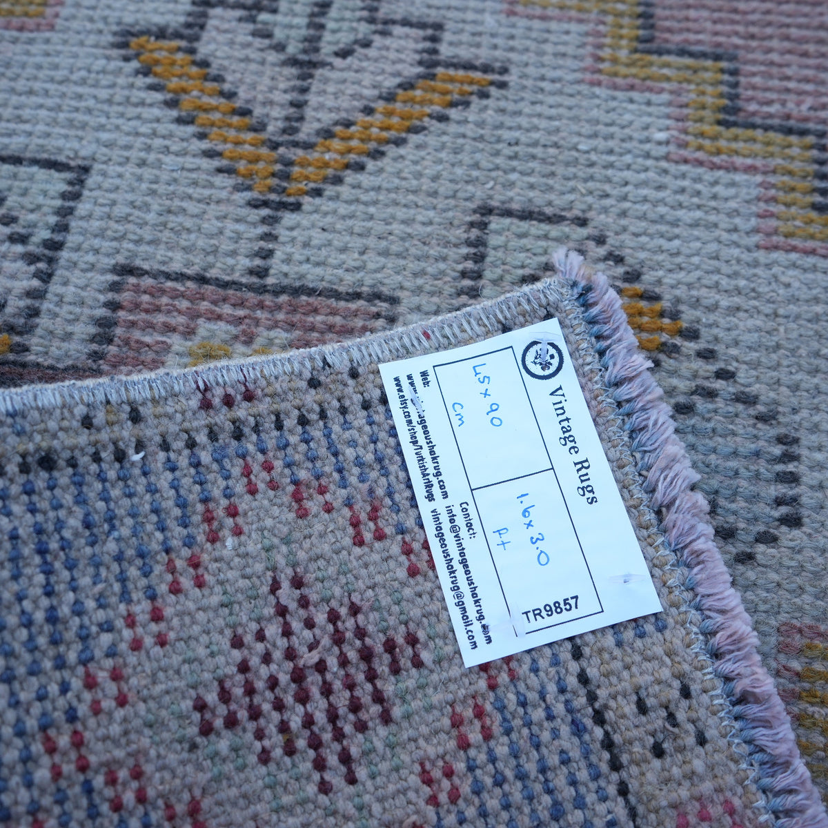 Pink 1' x 3' vintage turkish rug from the 1970s with traditional design.