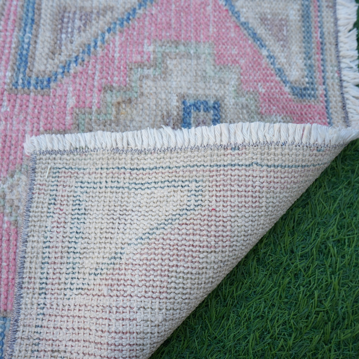 1970s pink vintage turkish rug with traditional design, hand-knotted weave and low pile.