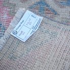 Pink 1' x 3' vintage turkish rug from the 1970s with traditional design.