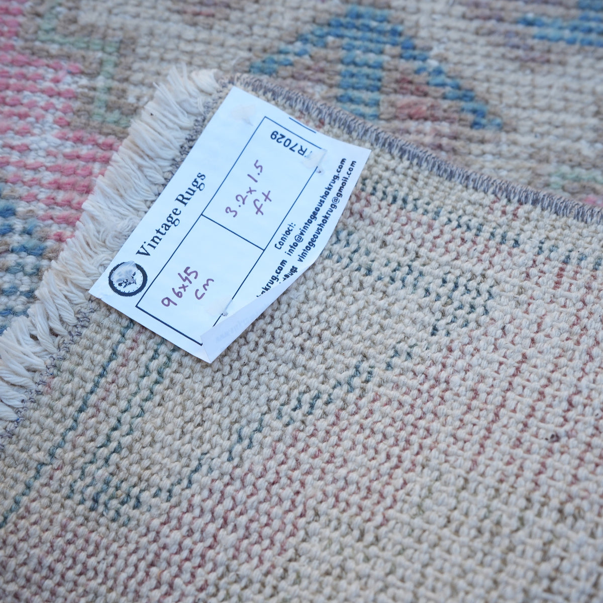 Pink 1' x 3' vintage turkish rug from the 1970s with traditional design.
