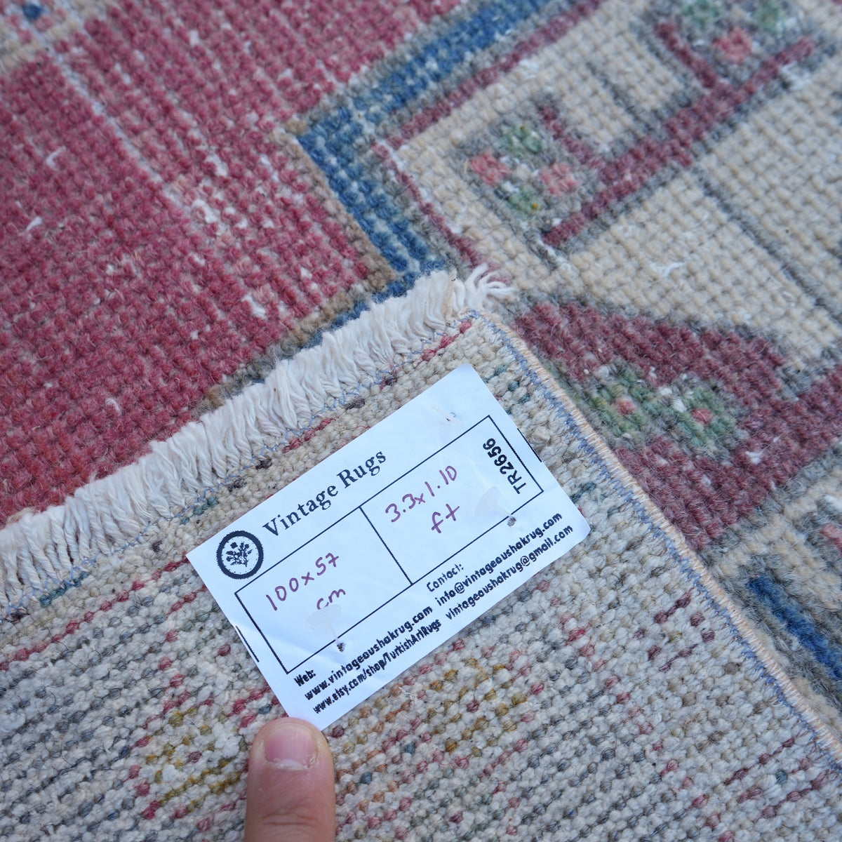 Red 1' x 3' vintage turkish rug from the 1970s with traditional design.