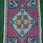 Close-up of the red vintage turkish rug showing traditional details, hand-knotted weave, wool and cotton and low pile.
