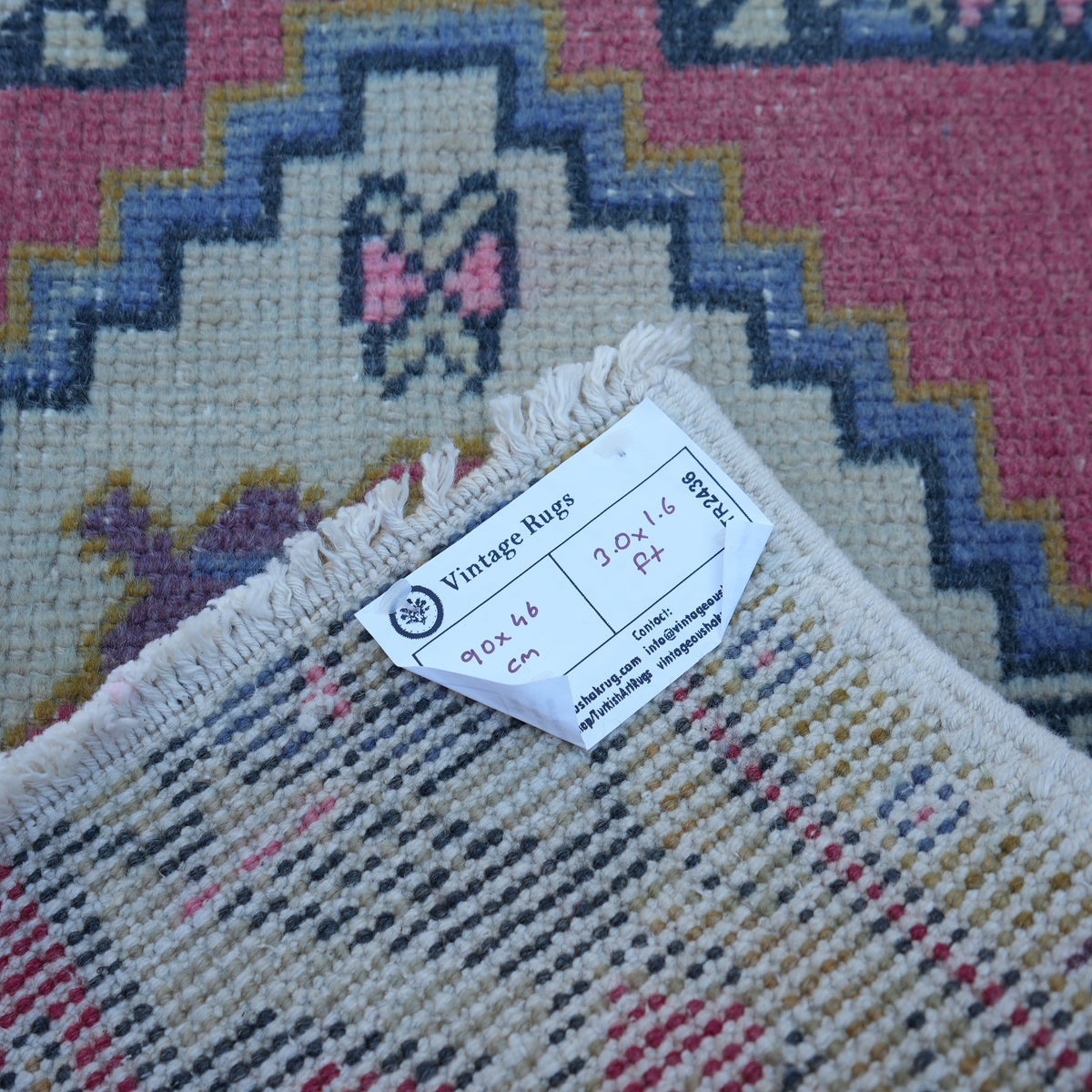 Red 1' x 3' vintage turkish rug from the 1970s with traditional design.