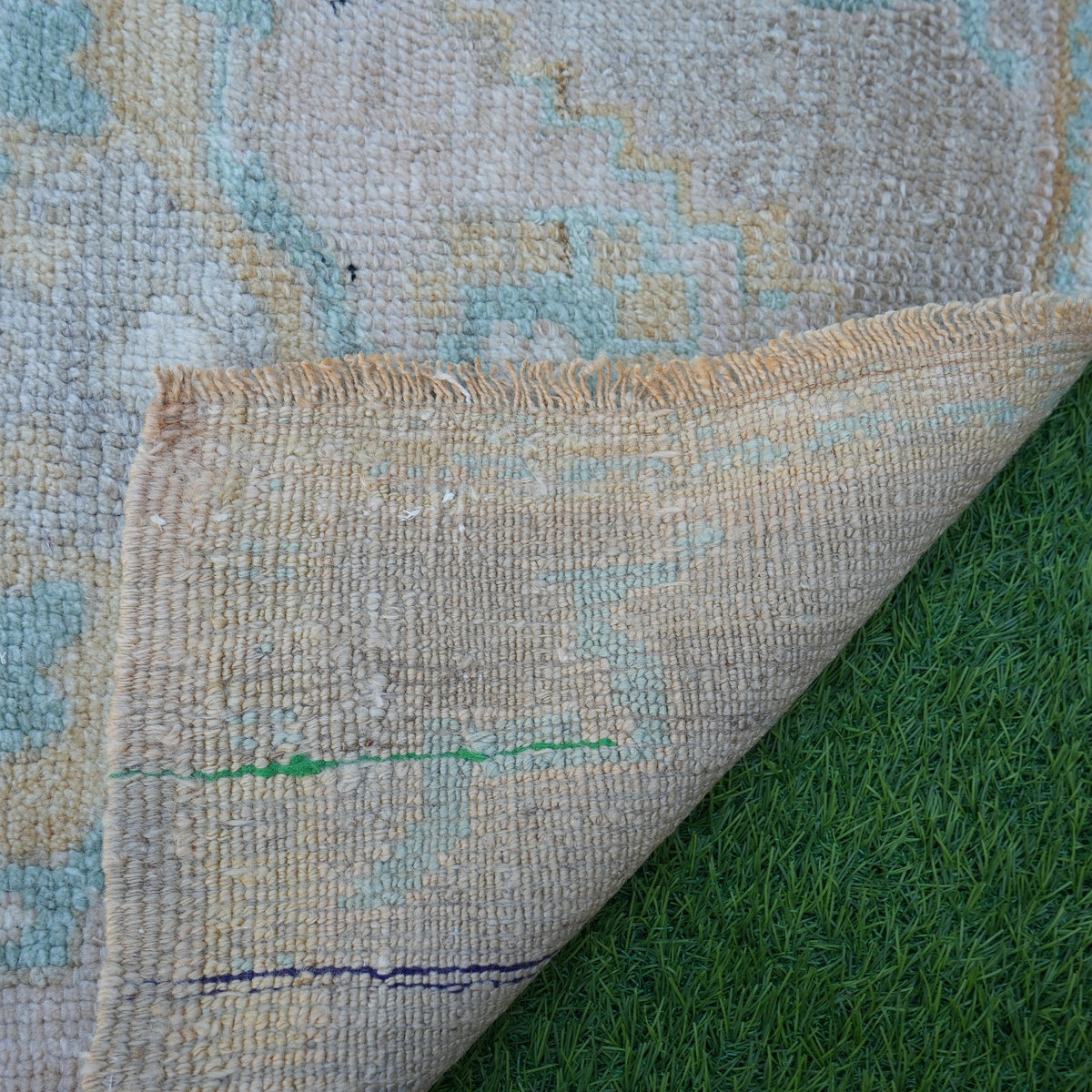 1970s beige vintage turkish rug with neutral design, hand-knotted weave and low pile.
