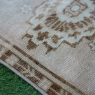 Beige 2' x 3' vintage turkish rug in wool and cotton, shown on the floor.